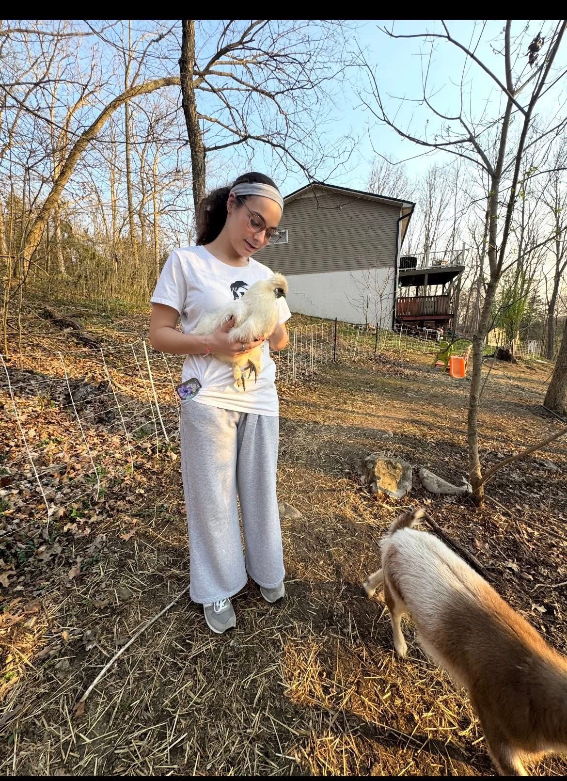 Brooklyn cradling a silkie chicken