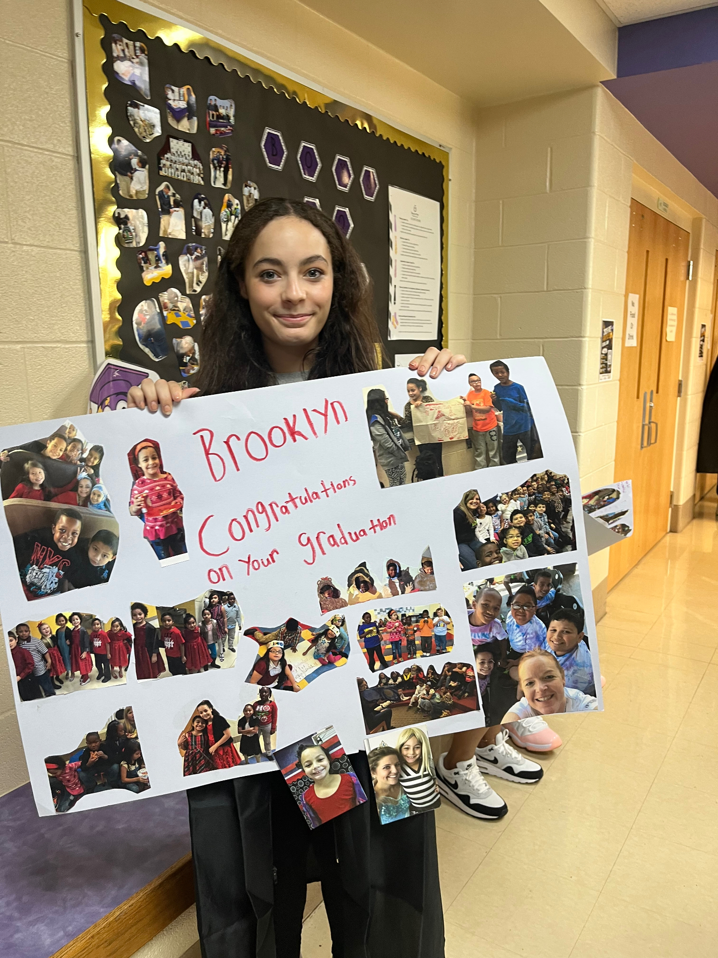 Brooklyn holding her elementary graduation collage
