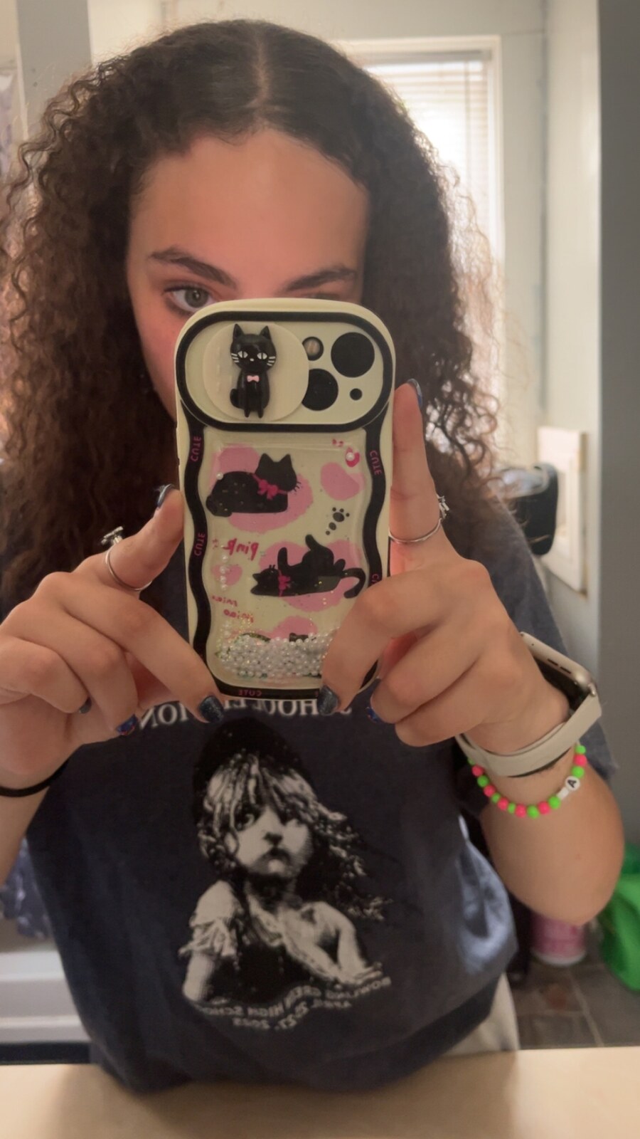 Brooklyn with her Les Mis tee and cat phone case